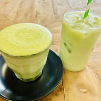 Iced and traditional matcha drinks served on a wooden table