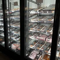 Refrigerated display cases stocked with a wide range of packaged meats